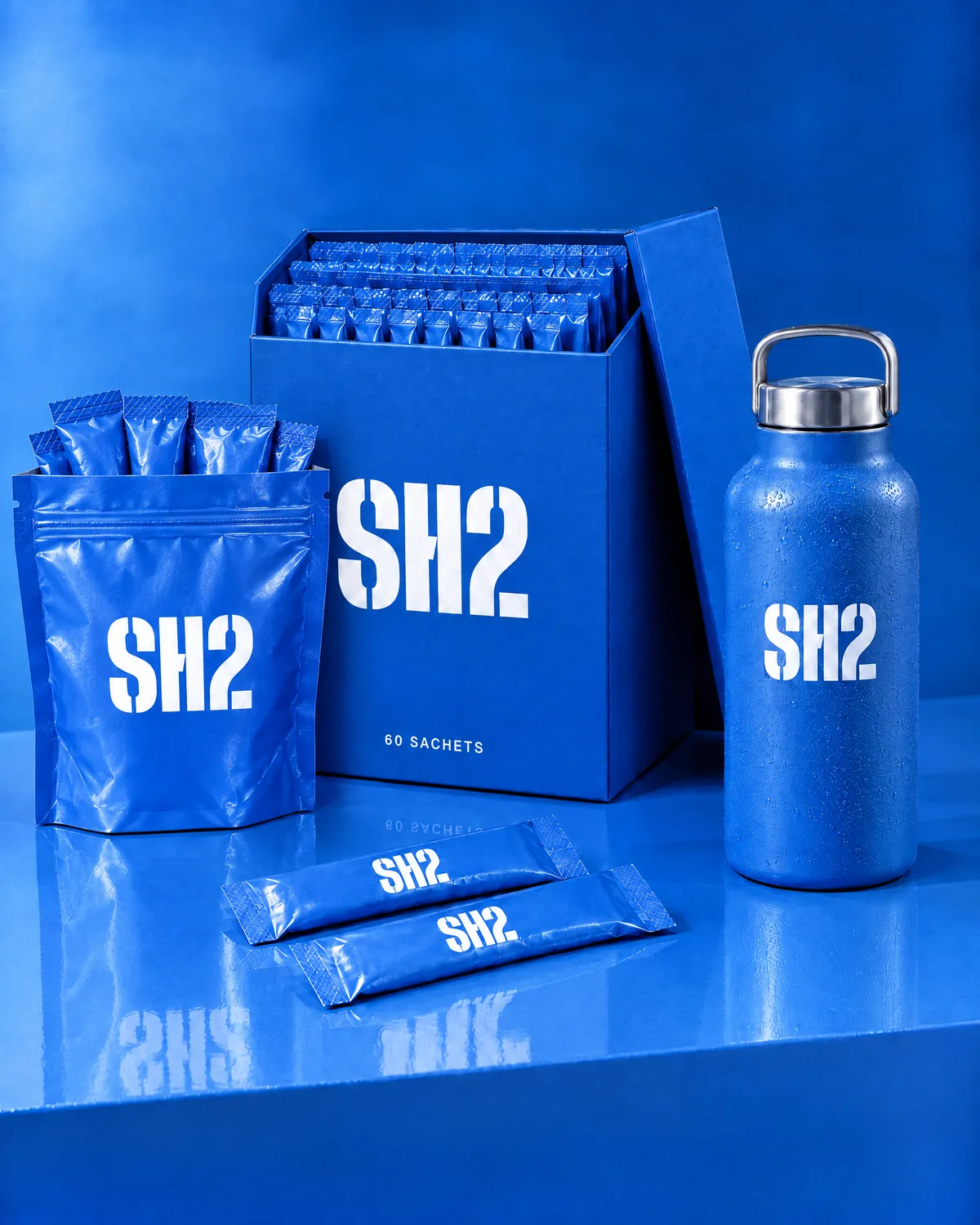 The SH2 starter kit: the open 60-sachet box, a zip travel pouch of sachets and the Mid Blue steel bottle